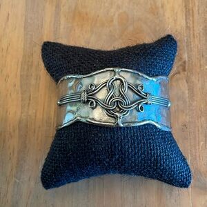 Silver (not marked) adjustable bangle with Celtic design 1.25” wide.